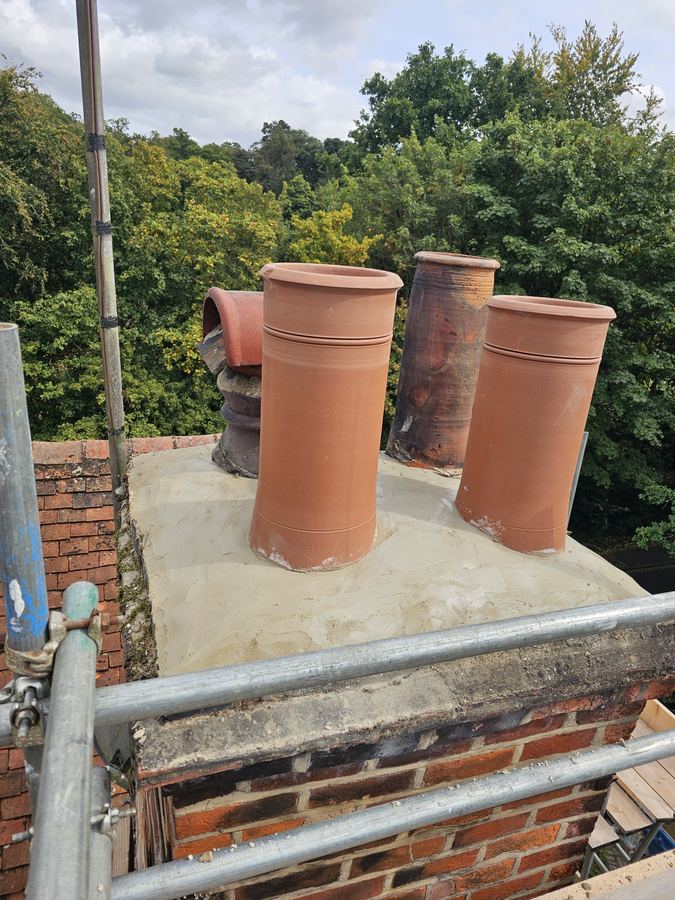 Rebuilt chimney stack, new and salvaged pots on lime haunching