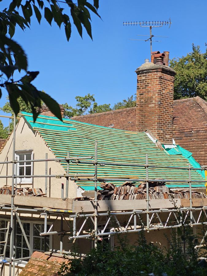 Thatch being worked on a period roof