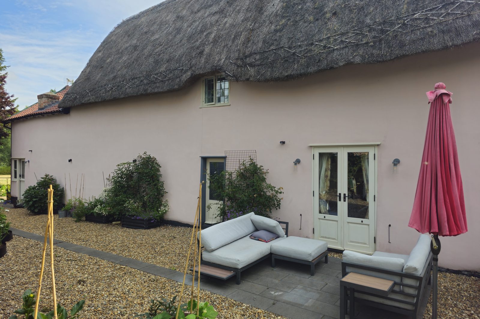 Rear elevation of a restored thatched Suffolk cottage